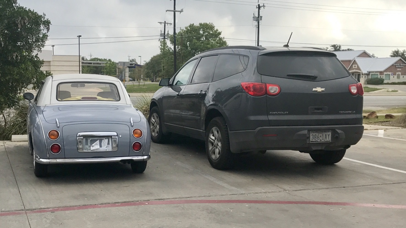 Little car next to a minivan.
